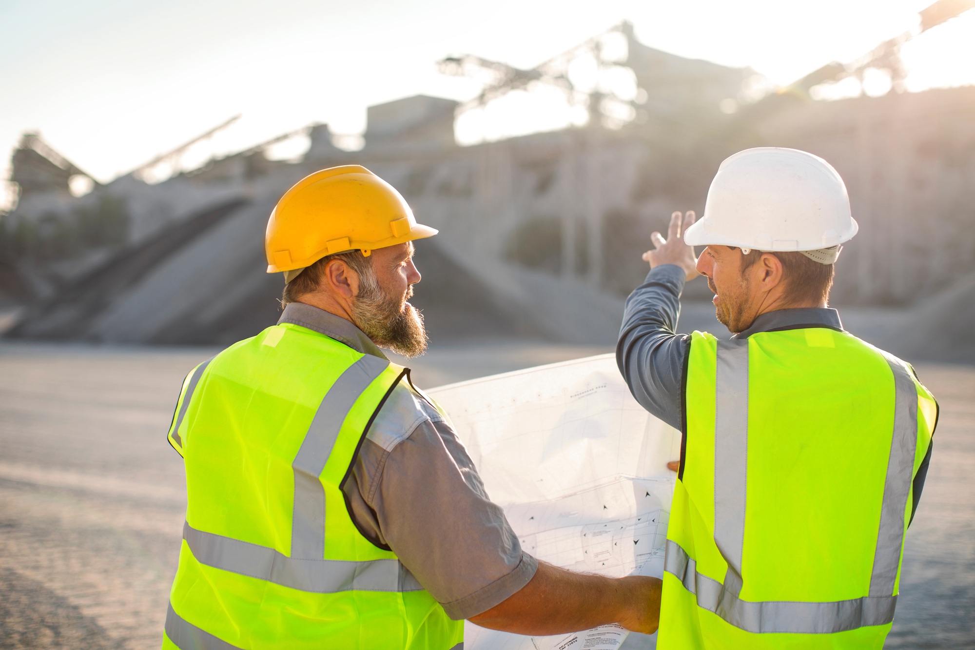 Quarry workers checking site plan